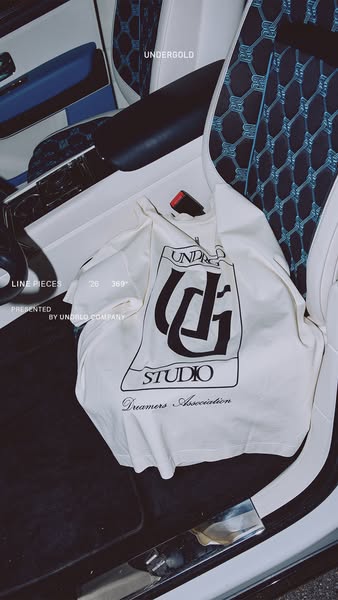 The ad showcases the brand's t-shirt placed inside the car, displaying the brand name and logo on the t-shirt.