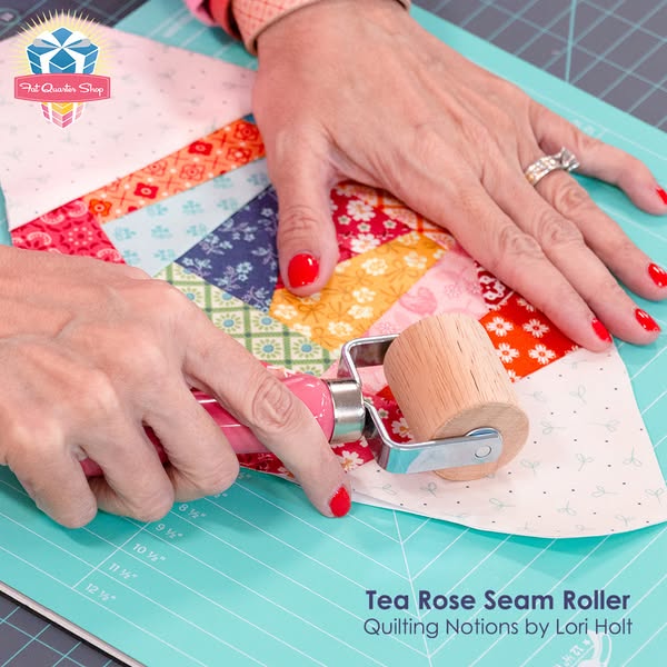 This image ad demonstrates a seam roller from the brand Fat Quarter Shop being used on a quilting project. The ad gives 