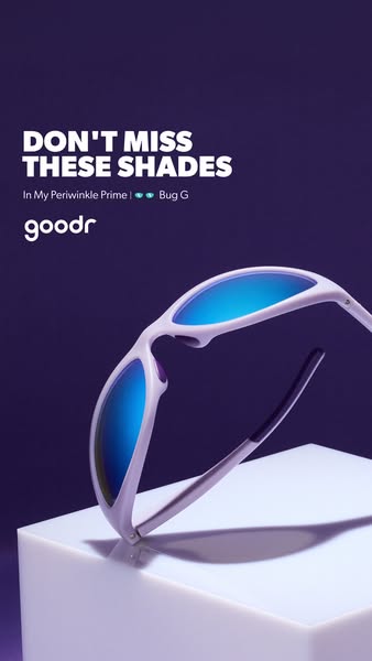 This image ad promotes Goodr sunglasses, showcasing a pair from the 'In My Periwinkle Prime' collection. The sun