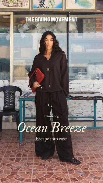 This ad is for The Giving Movement. It shows a person standing in front of a building, wearing clothing from the brand. 