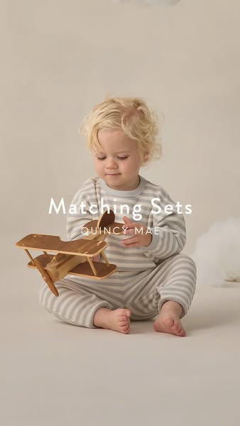 This ad features a young child wearing a matching pajama set from Quincy Mae, positioned against a neutral background an