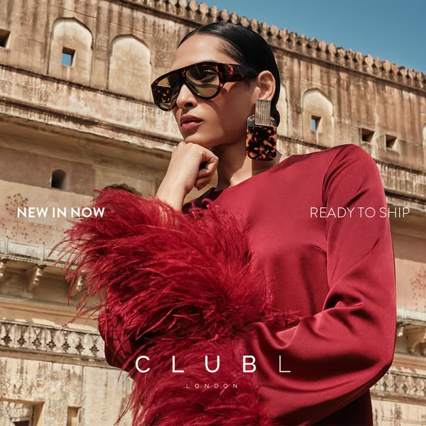 This Club L London ad features a model wearing clothing and accessories from the brand, set against a background reminis