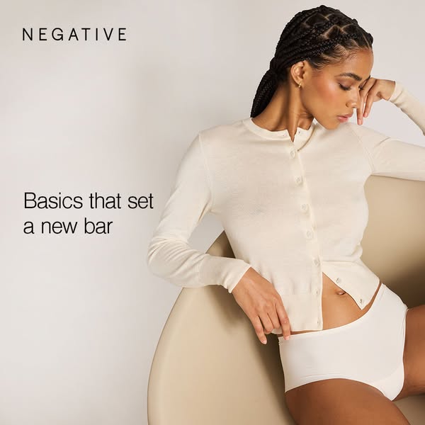 This image ad showcases a woman in Negative brand underwear and a cardigan, emphasizing comfort and style. The ad aims t