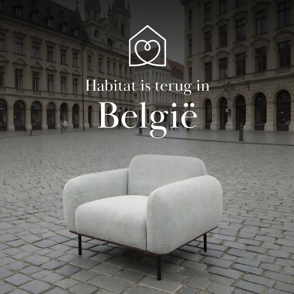 This image ad promotes Habitat's return to Belgium, featuring a plush armchair against an out-of-focus cityscape bac