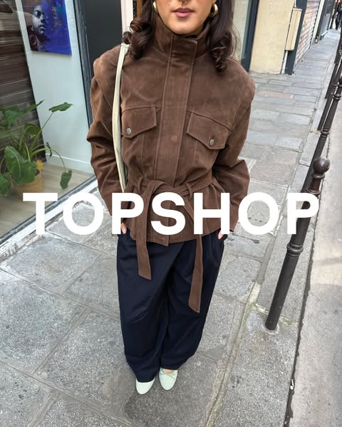 This image ad features a woman wearing a Topshop brand jacket. The ad focuses on showcasing the jacket, highlighting its