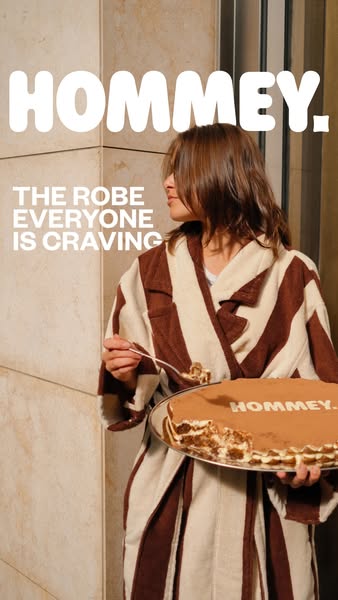 This image ad from Hommey features a person eating cake while wearing one of the brand's robes. The overall message