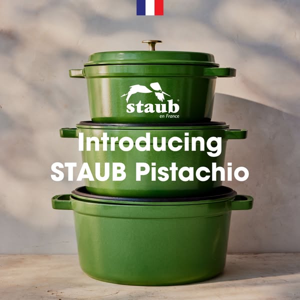 This image ad showcases a stack of pistachio-colored STAUB cookware in varying sizes, highlighting the brand's quali