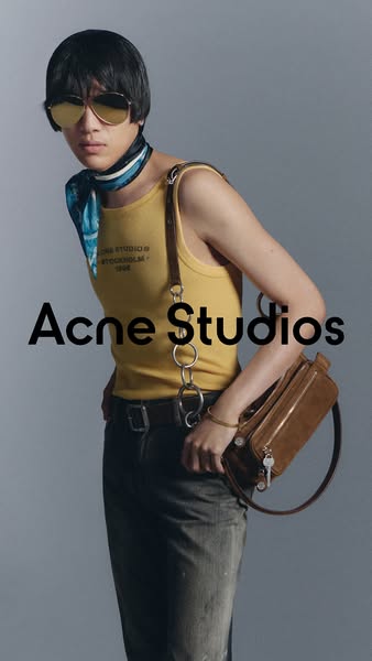 This ad features a person wearing Acne Studios apparel and accessories. The brand name is displayed in large text on the