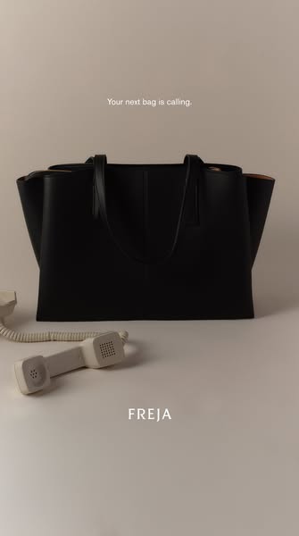 This ad features a Freja brand black tote bag. The ad utilizes a minimal aesthetic with a phone off to the side and the 