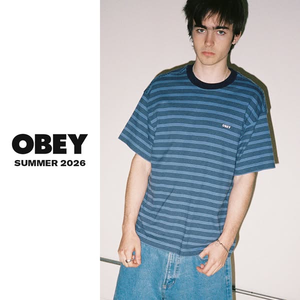 The ad features a young man wearing a blue, horizontally-striped t-shirt from the OBEY Summer 2026 collection. The setti
