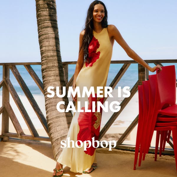 This Shopbop ad features a model wearing a long, patterned dress in a tropical setting, promoting summer fashion.