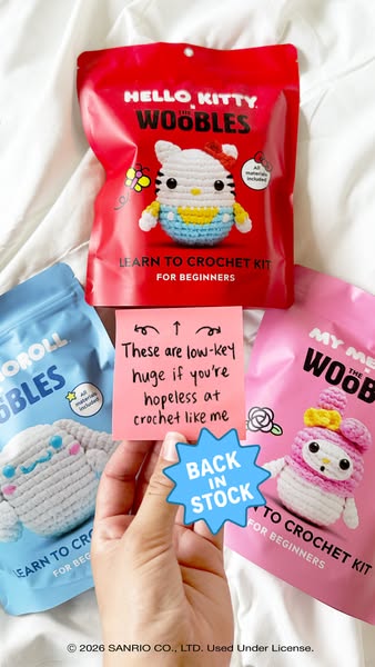 The ad features three learn to crochet kits from The Woobles, including Hello Kitty, Cinnamoroll, and My Melody. A hand 