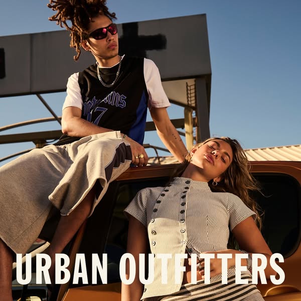 Image showcasing a man and woman in Urban Outfitters clothing on the hood of a vehicle.