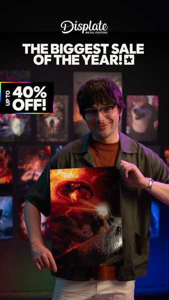 The ad promotes Displate metal posters and features their biggest sale of the year, offering up to 40% off. A man is hol