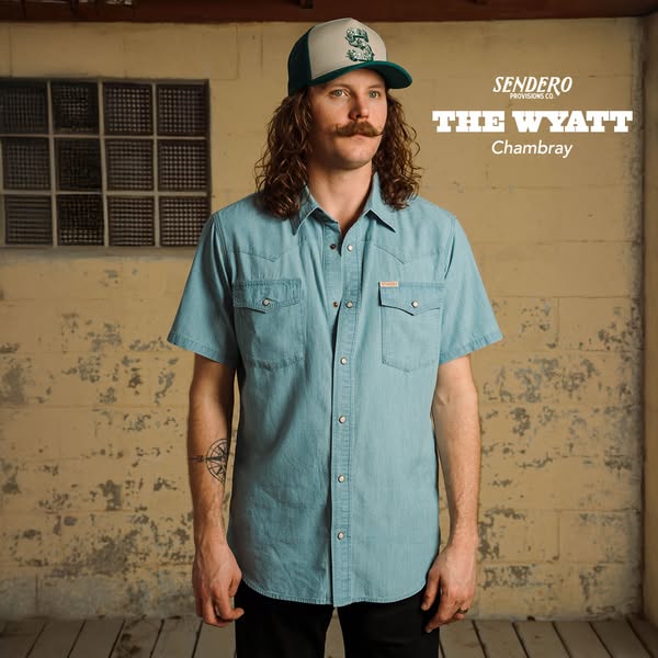 This ad features a man wearing the 'Wyatt Chambray' shirt from Sendero Provisions Co. The ad highlights the shir