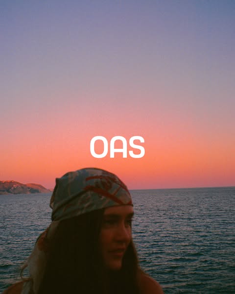 This image ad features a woman posing in front of a sunset over the ocean, with the brand name, OAS, in white text layer