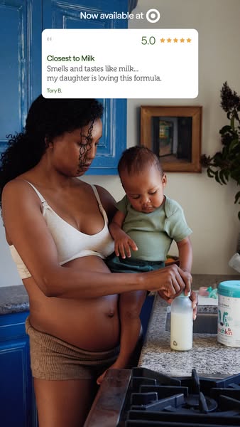 This ad features a woman holding her baby while opening a bottle of formula. A quote from a customer testimonial is feat