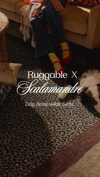 This ad is for Ruggable rugs in collaboration with Scalamandré, featuring a woman sitting on a couch with a dog on the r