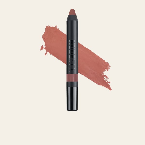 This ad features a NUDESTIX lip product in a neutral tone. The ad focuses on the product itself, showcasing its color an