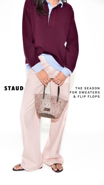 This ad showcases a straw bag from STAUD, styled with a sweater, collared shirt, and pants. The ad highlights the bag as