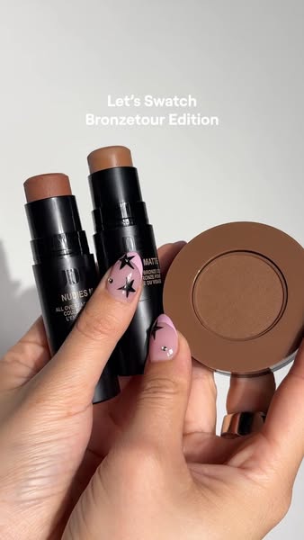 This ad showcases three bronzer and contour products from Nudestix: two Nudies Matte All-Over Bronze Color sticks and on