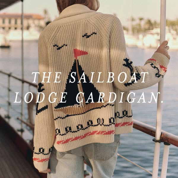 This image ad showcases a cream-colored knit cardigan with a sailboat design, likely targeted toward women interested in