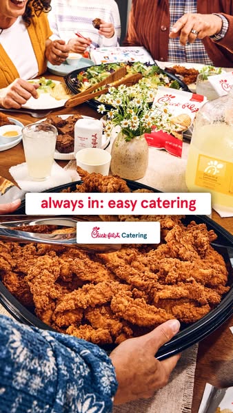 A wide group of people are enjoying a catered meal of Chick-fil-A. The ad promotes how easy it is to have Chick-fil-A ca