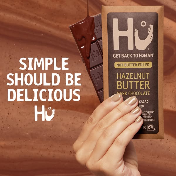 This ad promotes Hu Hazelnut Butter Dark Chocolate. The visual focus is on the chocolate bar with melting chocolate bein