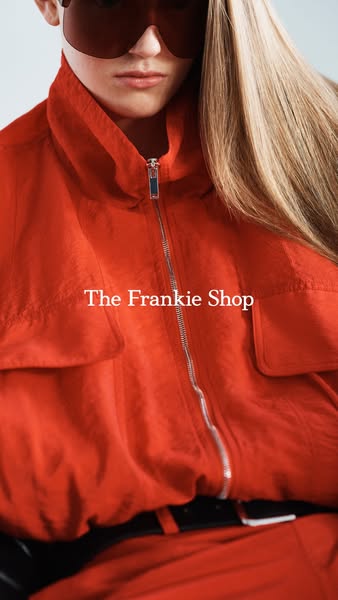 This ad showcases an orange full zip jacket with matching pants from The Frankie Shop.