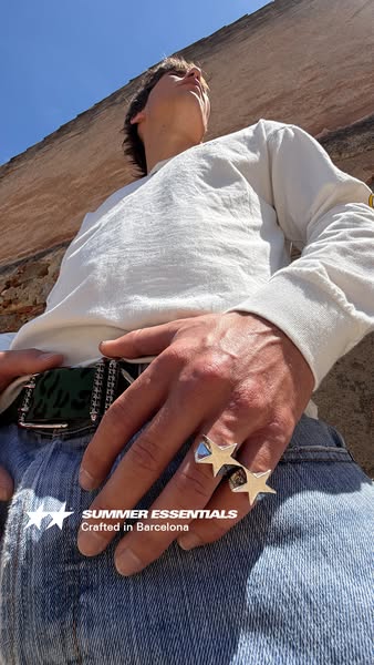 This ad features a person with two star-shaped rings on their fingers. Text at the bottom reads "Summer Essentials 