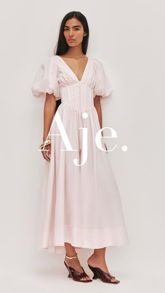 This ad features a full-length shot of a woman wearing a light pink dress from the brand Aje.
