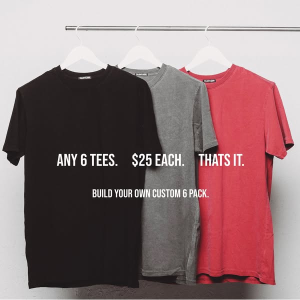 The ad features three t-shirts in different colors hanging on a white hanger against a light gray background. The text o