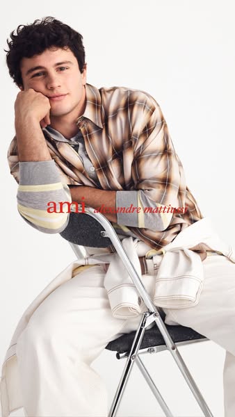 This ad features an image of a male model wearing a Ami Alexandre Mattiussi shirt and pants. The overall image conveys a