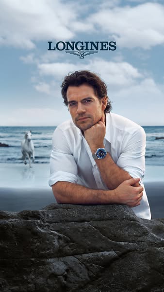 This ad features Henry Cavill on a beach wearing a Longines watch. A white horse runs in the background near the water.