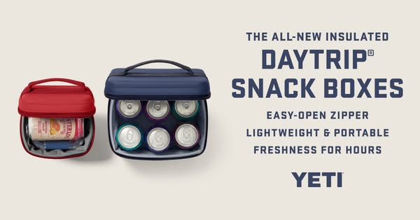 This ad features two YETI Daytrip snack boxes, one red and one navy, each containing food and beverage items, and highli