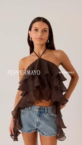 A static image showcasing a brand’s new arrival ruffled halter top worn by a model.