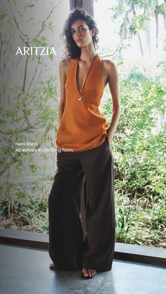 This Aritzia image ad promotes new linen clothing, featuring a model wearing a halter top and wide-leg pants.