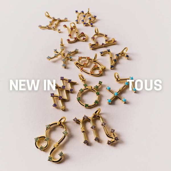 This image ad showcases a series of zodiac sign charms from TOUS, highlighting their new collection.