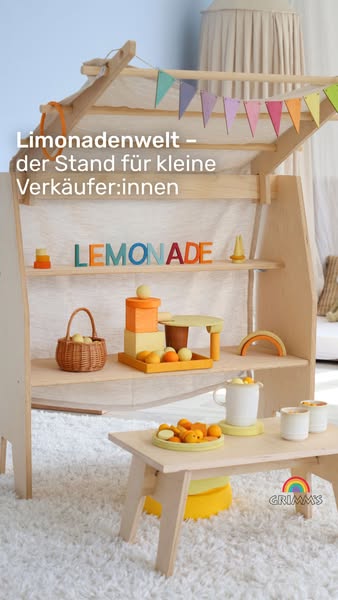 This ad showcases a children's lemonade stand and related toy accessories from the Grimms brand.