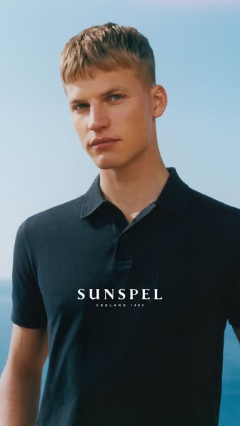 The ad features a light-skinned man wearing a dark polo shirt, positioned against a bright blue sky and ocean background