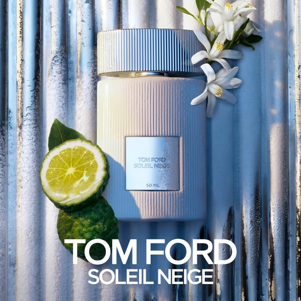 The Tom Ford Soleil Neige ad is a product-focused still life image. It features a bottle of Soleil Neige perfume, surrou