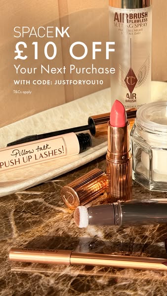 The ad features several Charlotte Tilbury makeup products arranged on a marble surface, accompanied by a discount offer 