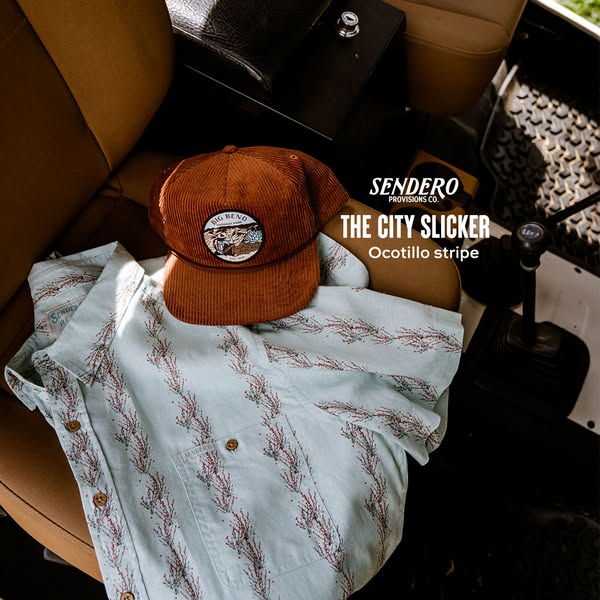 This ad showcases a hat and button-down shirt from Sendero Provisions Co. placed on the seat of a vehicle, implying a li
