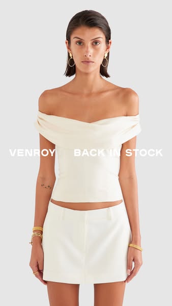 This ad features a woman wearing a white top and skirt from Venroy. The text overlay indicates that the item is back in 