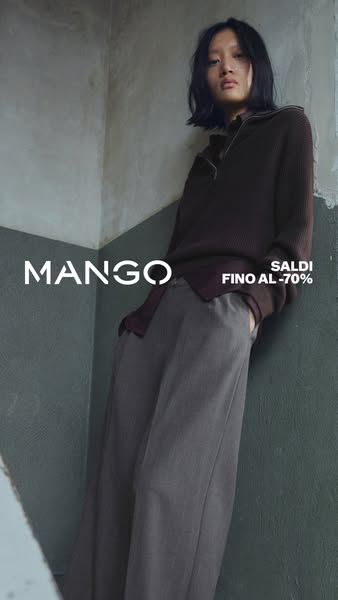 This ad for Mango features a model leaning against a wall wearing a brown sweater and wide leg gray pants. The ad spotli