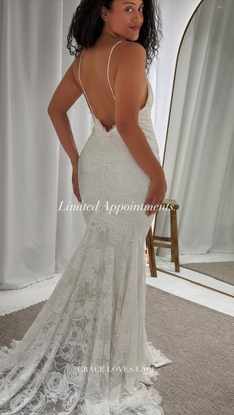 This image ad for Grace Loves Lace features a woman wearing a low-back lace wedding gown. The ad mentions limited appoin