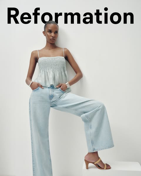 This ad showcases Reformation's clothing and shoes. A model is featured wearing a blue top, wide leg jeans, and a pa