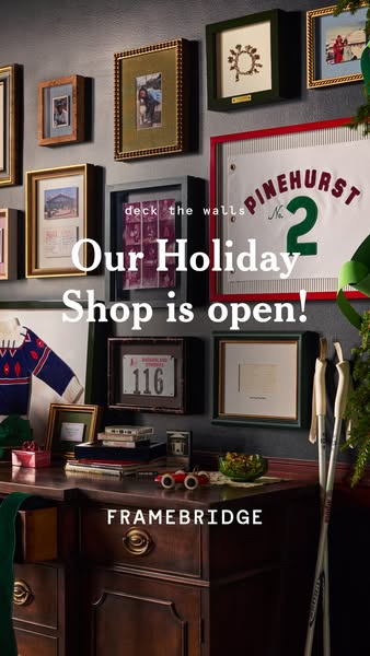 This image ad for Framebridge promotes their holiday shop. The ad features a collection of framed items on a wall above 