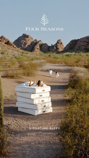 This image ad for Four Seasons mattresses features a stack of mattresses in a desert landscape with a woman lounging on 