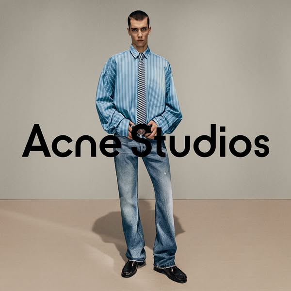 This image ad showcases Acne Studios' brand and clothing line, featuring a male model wearing a striped shirt, tie, 